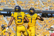Aug 30, 2025; Morgantown, West Virginia, USA; West Virginia Mountaineers running back Jahiem White (1) scores a touchdown and celebrates with West Virginia Mountaineers wide receiver Jaden Bray (5) during the third quarter at Milan Puskar Stadium. Mandatory Credit: Ben Queen-Imagn Images. NCAA Football: Robert Morris at West Virginia - Source: Imagn